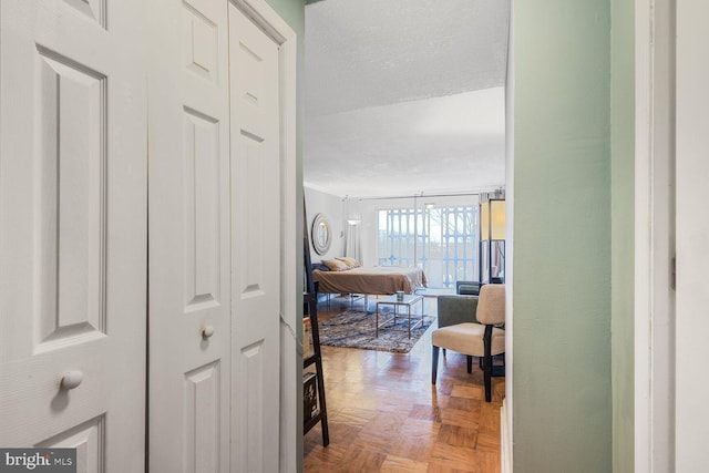 hall featuring a textured ceiling