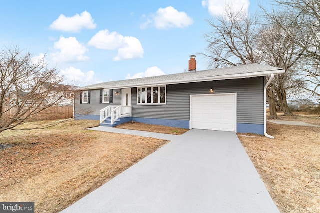 single story home with a garage, driveway, a chimney, and a front yard