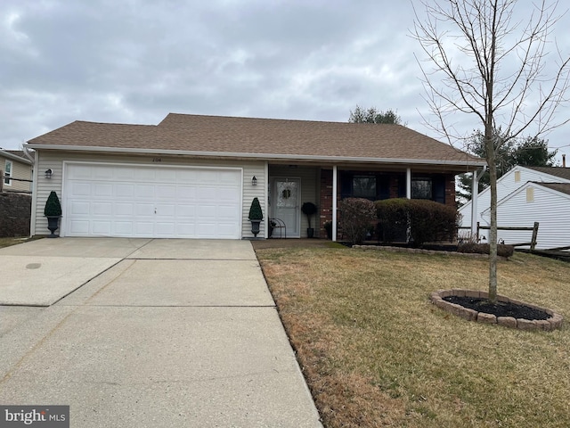 ranch-style house featuring a front yard, an attached garage, driveway, and roof with shingles