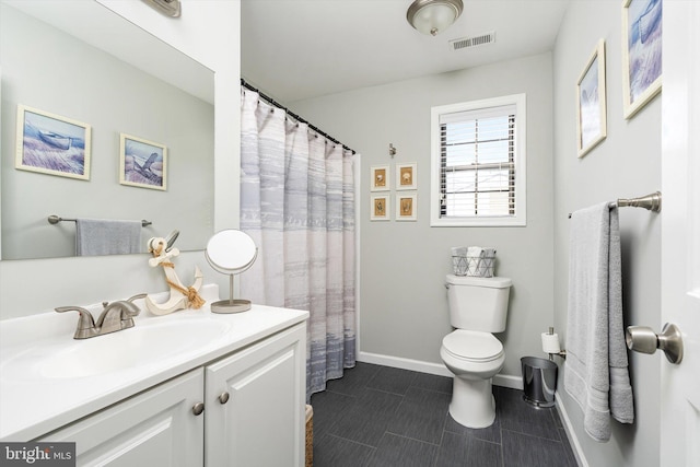 bathroom with visible vents, toilet, vanity, and baseboards