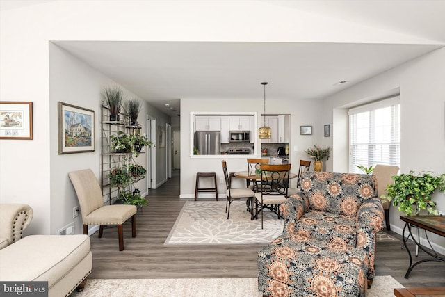 living room featuring baseboards and wood finished floors