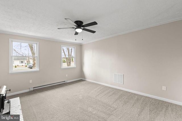 empty room featuring a textured ceiling, a baseboard heating unit, carpet flooring, visible vents, and crown molding