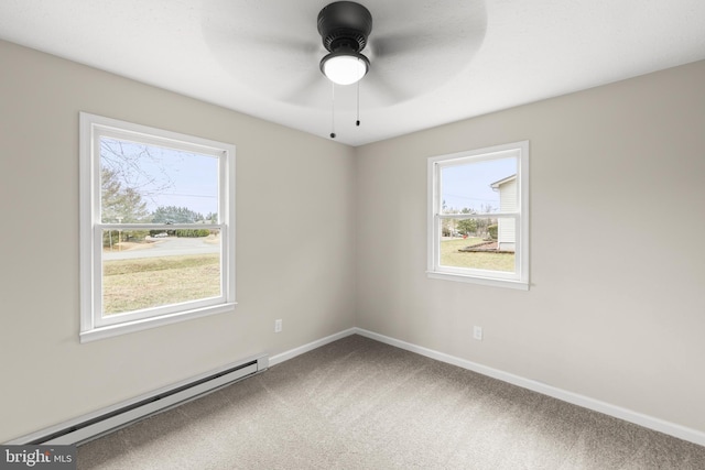 carpeted spare room featuring a baseboard heating unit, a ceiling fan, and baseboards