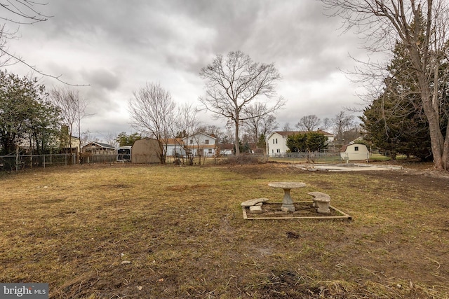 view of yard featuring an outbuilding and fence