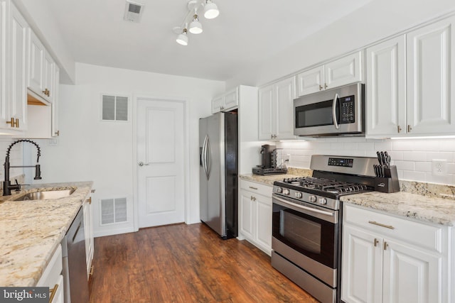 kitchen with stainless steel appliances, a sink, and visible vents