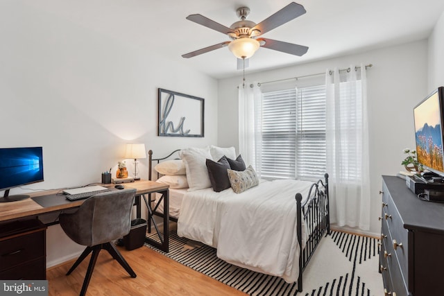 bedroom featuring light wood-type flooring and a ceiling fan