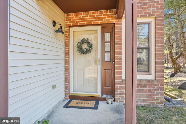 property entrance featuring brick siding