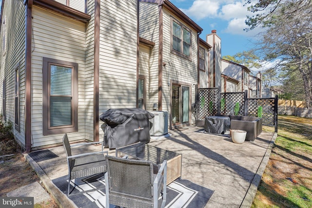 view of patio / terrace featuring fence and grilling area