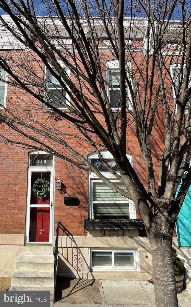 doorway to property with brick siding