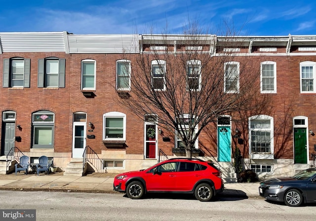 multi unit property featuring entry steps and brick siding