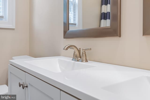 bathroom featuring toilet and vanity