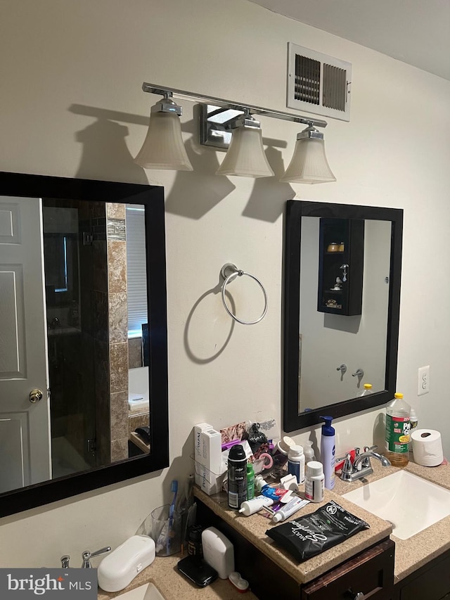 bathroom with vanity and visible vents