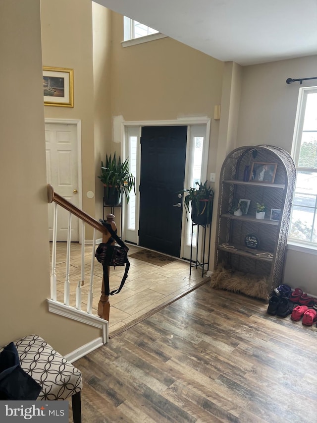 entrance foyer featuring stairway, wood finished floors, and baseboards