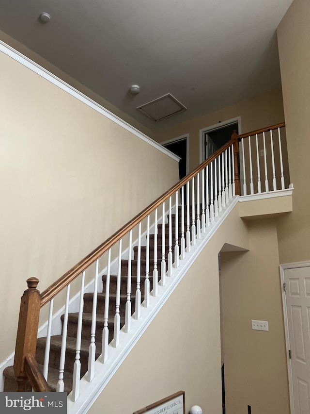 stairs with a towering ceiling and baseboards