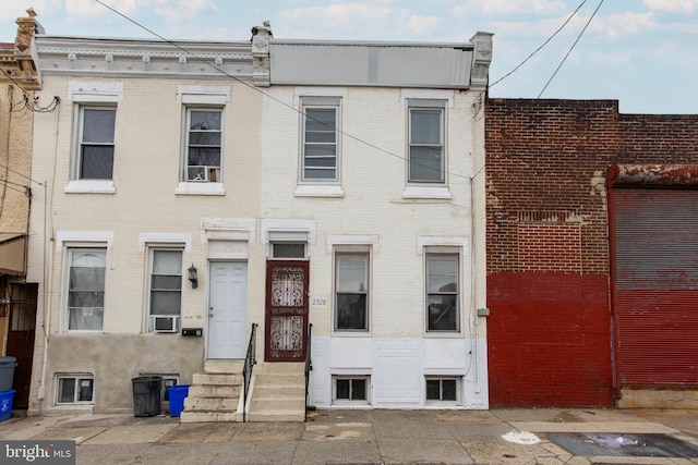 townhome / multi-family property featuring entry steps and brick siding