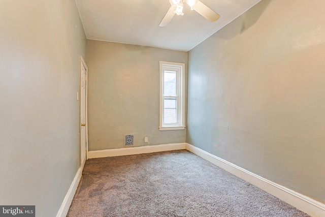 spare room featuring carpet floors, baseboards, and a ceiling fan