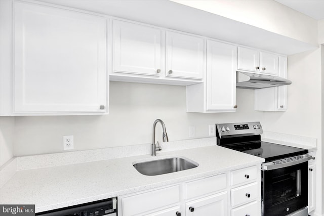 kitchen with electric stove, white cabinets, a sink, and under cabinet range hood