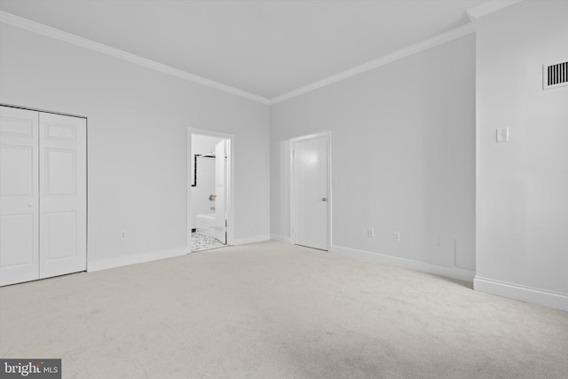 unfurnished bedroom with ornamental molding, carpet flooring, and baseboards