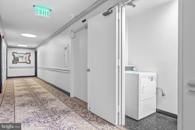 hallway with ornamental molding, washer / clothes dryer, baseboards, and speckled floor