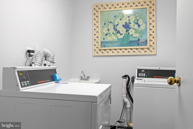 washroom featuring washer and dryer and a sink