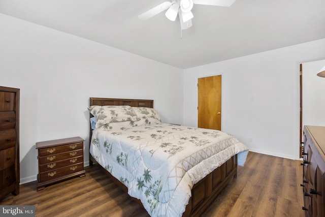 bedroom with a ceiling fan, dark wood finished floors, and baseboards