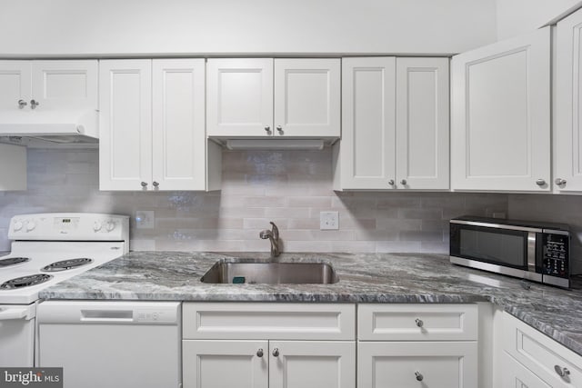 kitchen featuring white appliances, a sink, white cabinetry, and under cabinet range hood