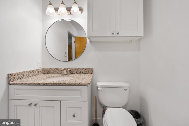 half bath with vanity and toilet