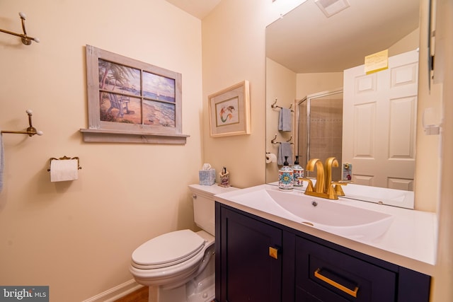 bathroom with visible vents, toilet, a shower stall, baseboards, and vanity