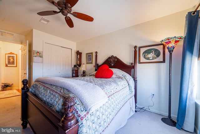 bedroom featuring a closet, visible vents, carpet flooring, and ceiling fan