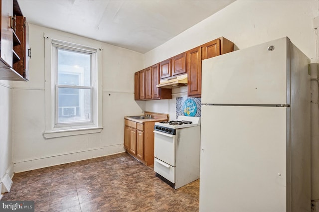 kitchen featuring white appliances, a sink, under cabinet range hood, brown cabinets, and backsplash