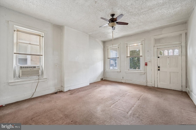 entryway featuring a textured ceiling, carpet, and a ceiling fan