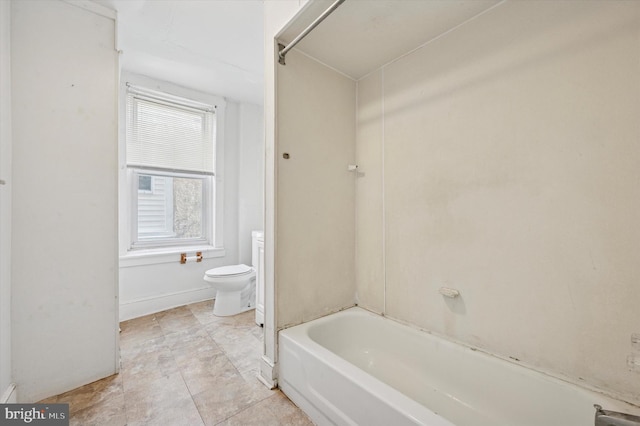 bathroom featuring toilet and baseboards