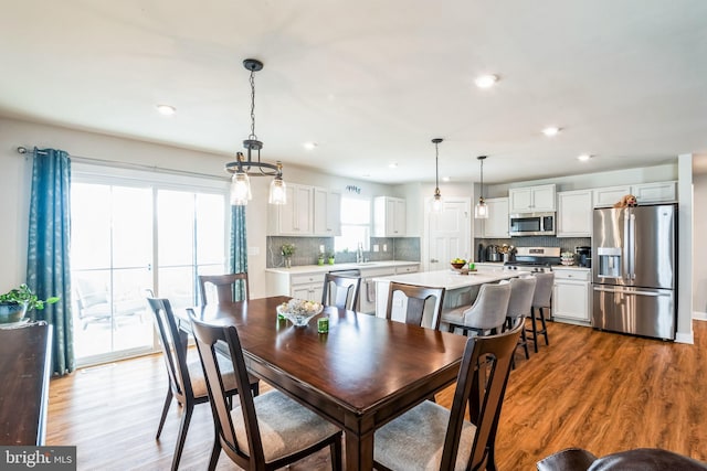 dining space with recessed lighting and wood finished floors