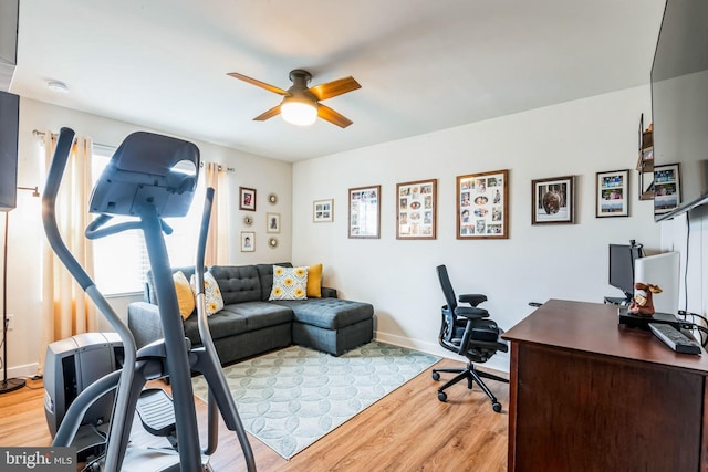 home office featuring ceiling fan, wood finished floors, and baseboards