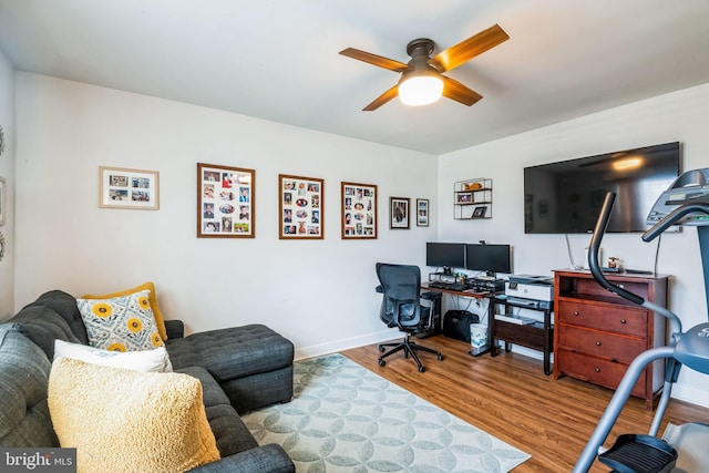 office area with ceiling fan, wood finished floors, and baseboards