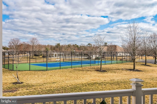 exterior space featuring a tennis court and fence