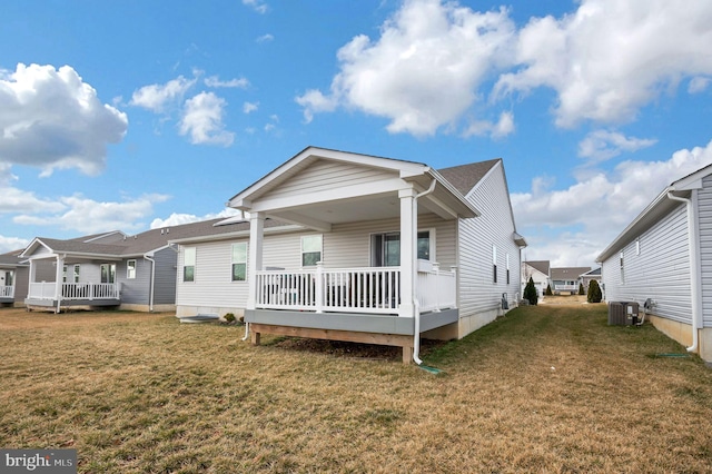 back of house featuring central AC and a lawn