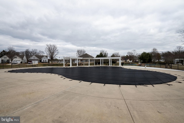 community pool featuring a patio area, fence, and a pergola