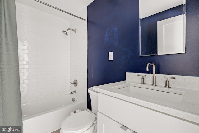 bathroom featuring vanity, shower / bath combo with shower curtain, and toilet