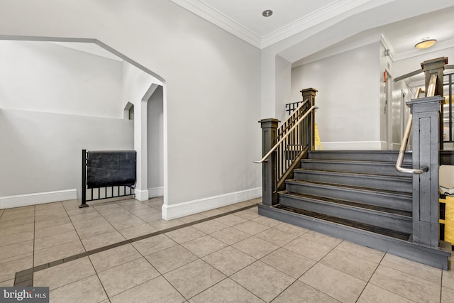 stairway featuring crown molding, tile patterned flooring, and baseboards