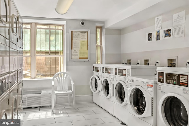 common laundry area featuring stacked washer / dryer, baseboards, and washing machine and clothes dryer