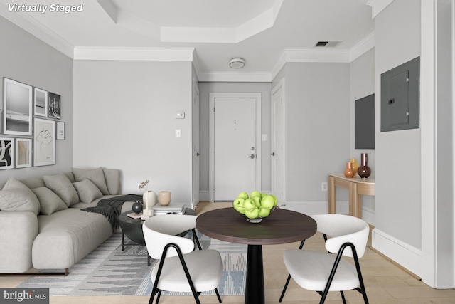 dining space with light wood finished floors, electric panel, visible vents, and ornamental molding