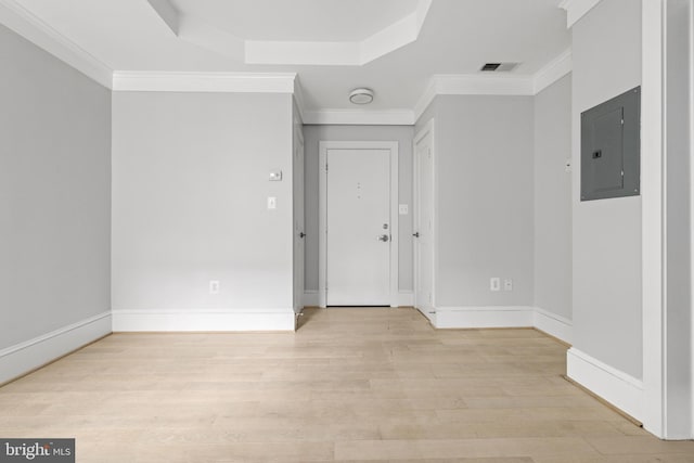 spare room featuring electric panel, visible vents, crown molding, and light wood-style flooring