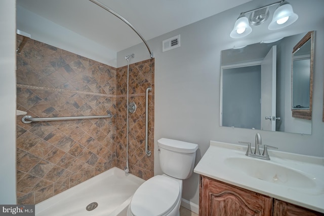 bathroom with a stall shower, visible vents, vanity, and toilet