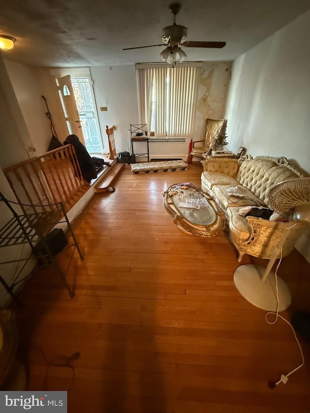 living room featuring wood finished floors and a ceiling fan