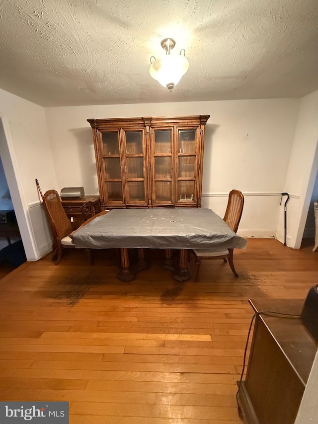 332 Emerson St NW, Washington, DC 20011 - dining room featuring light wood-style flooring and a textured ceiling