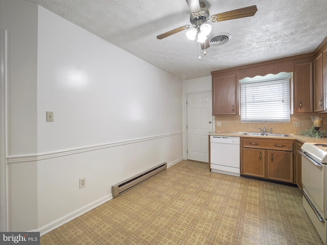 kitchen with white dishwasher, a sink, stove, light countertops, and a baseboard heating unit