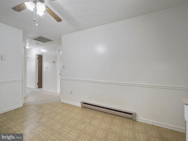 spare room featuring baseboards, visible vents, ceiling fan, a textured ceiling, and baseboard heating