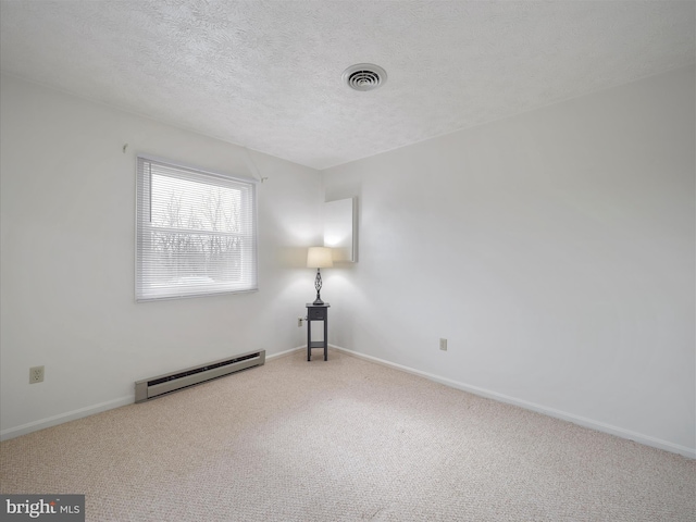 carpeted empty room featuring a baseboard radiator, baseboards, a textured ceiling, and visible vents