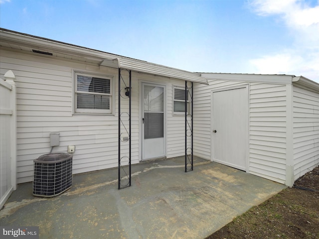 doorway to property featuring central AC and a patio area